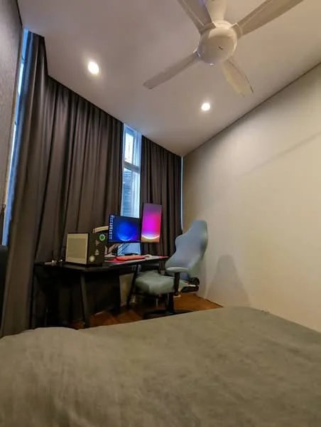 Room features: grey wall, wooden flooring, 5-blade ceiling fan, recessed LED downlights, floor-to-ceiling window, blackout curtains, desk with computer monitors, ergonomic office chair, small white cabinet; style: modern.