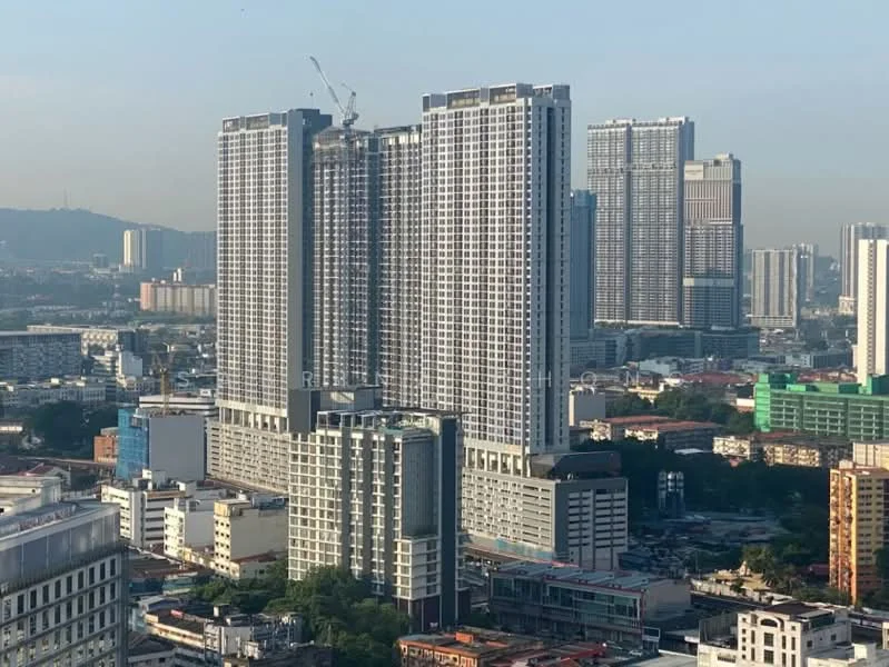 Exterior type: high-rise condominium; features: glass curtain wall, recessed balconies, approximately 30-storey high-rise, surrounded by urban landscape, construction crane visible, adjacent to other high-rise buildings; style: modern.
