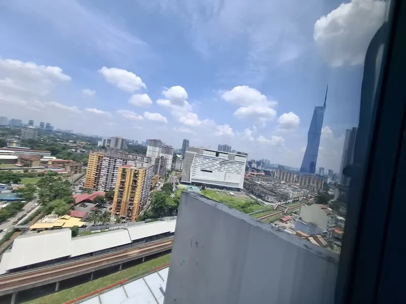 Exterior type: high-rise condominium; features: city skyline view, surrounded by urban landscape, visible railway tracks, multiple high-rise buildings, green spaces, clear blue sky with clouds; style: modern.