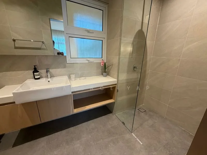 Bathroom features: single-sink vanity with wood cabinet, white countertop, mirror above sink, glass shower enclosure, rain shower head, wall-mounted faucet, tile cladding on walls, grey tile flooring, plant decoration, window with sheer curtains; style: modern.