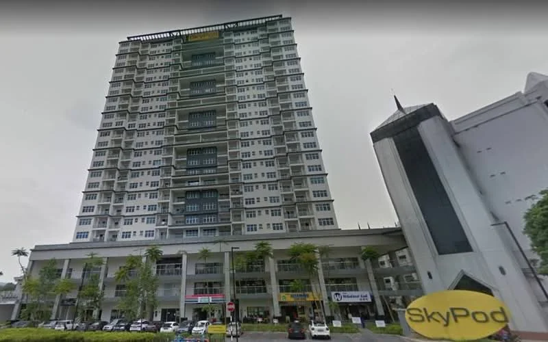 Exterior type: high-rise condominium; features: glass curtain wall, white painted facade, projecting balconies, commercial units on ground floor, palm trees in landscaping, multiple storeys, modern architectural design, visible signage for businesses; style: modern.