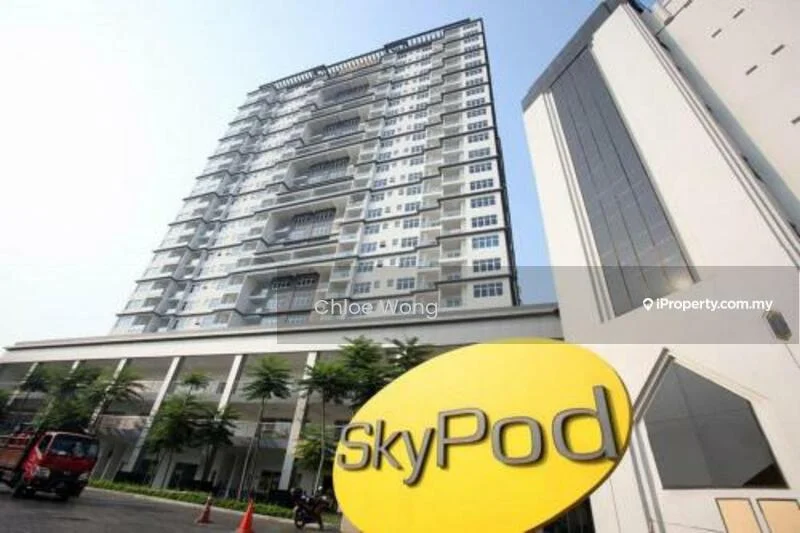 Exterior type: high-rise condominium; features: glass curtain wall, white painted facade, recessed balconies, approximately 15-storey high-rise, manicured lawn, mature trees, signage with 'SkyPod', entrance with driveway; style: modern.