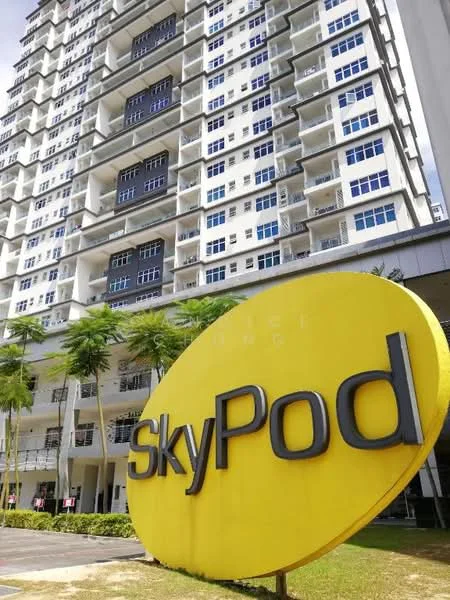 Exterior type: high-rise condominium; features: glass curtain wall, yellow signage with 'SkyPod', multiple balconies, manicured lawn, palm trees, surrounded by greenery; style: modern.