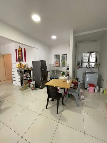Kitchen features: white painted walls, glossy white tile flooring, refrigerator, kitchen cabinets with multiple compartments, dining table with chairs, washing machine, sink, ceiling lights, window with metal grills, plastic storage containers, fan, broom and cleaning supplies.