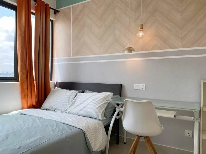 Bedroom features: queen-size bed with grey bedding, striped white and grey pillowcases, wooden headboard, study desk with white chair, pendant light fixture, chevron patterned feature wall, light grey painted walls, floor-to-ceiling window with orange curtains, neutral tile flooring; style: modern; view: city.