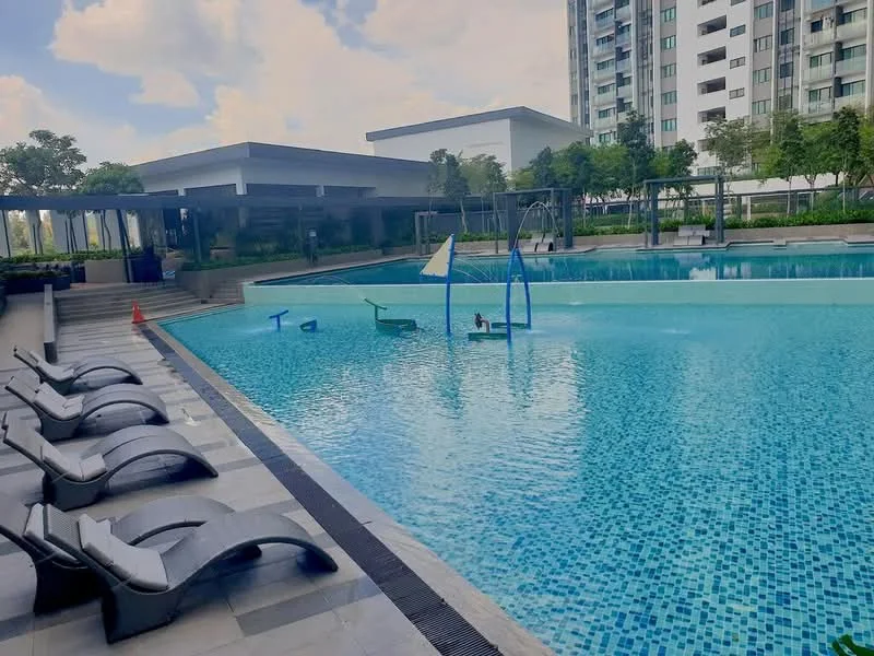 Exterior type: swimming pool deck; features: infinity pool, pool deck with loungers, tropical landscaping, manicured lawn, children's playground, water features, shaded seating area, paved walkway; style: modern.