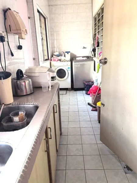 Laundry features: single-bowl stainless-steel sink, white cabinetry, countertop, front-load washing machine, stainless-steel fridge, kettle, toaster, tile flooring, window for natural light, various cleaning supplies, plastic storage bins.