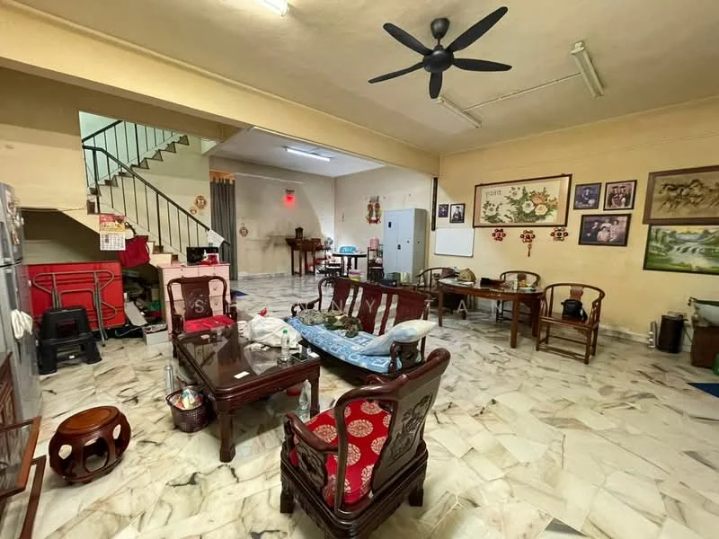 Living features: marble flooring, cream painted walls, exposed ceiling with fluorescent lights, 5-blade ceiling fan, wooden dining table, wooden chairs, framed artwork on walls, decorative wall clock, refrigerator, staircase leading to upper floor, open layout, area rug, small round wooden table, various decorative items on tables; style: traditional.