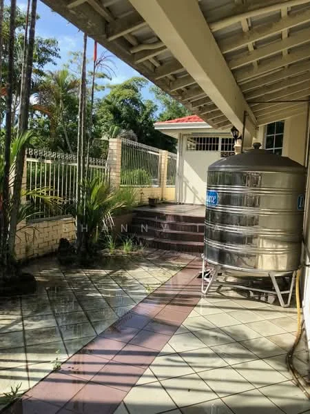 Exterior type: detached bungalow; features: water storage tank, paved walkway, landscaped garden, fenced perimeter, steps leading to entrance, tropical plants, roof overhang, brick wall, tile flooring, gated entry; style: modern.
