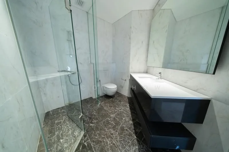 Bathroom features: marble wall cladding, black marble flooring, walk-in shower with glass enclosure, chrome shower head, single-sink vanity with white countertop, modern faucet, framed mirror, one-piece toilet; style: modern.