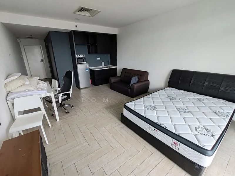 Living features: queen-size bed, upholstered headboard, fabric sofa in dark brown, white dining chair, study desk, wooden TV console, kitchenette with sink, black cabinetry, tile flooring, air conditioning unit, wall-mounted mirror, light-colored walls, window with natural light; style: modern.