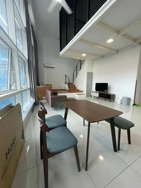 Living features: large floor-to-ceiling windows, grey curtains, white painted walls, polished tile flooring, sofa in dark brown, TV console, wall-mounted TV, wooden dining table, 3 wooden chairs with blue cushions, air conditioning unit, staircase leading to upper level, decorative wall paneling; style: modern; view: city.