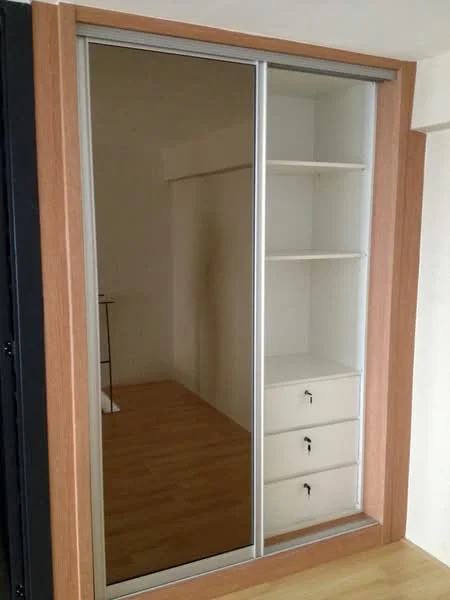 Room features: sliding mirror wardrobe, wooden cabinetry, three drawers, open shelving, light wood flooring; style: modern.