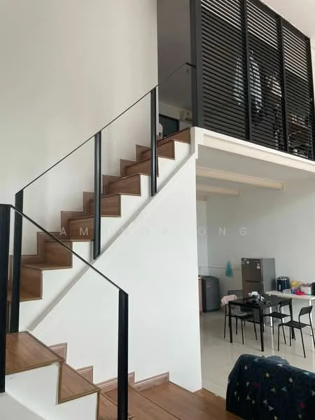 Staircase features: wooden staircase with open risers, black metal railing, white painted walls, high ceiling, natural light from upper level; style: modern. Dining features: dining table with chairs, grey cabinetry, stainless-steel fridge, ceramic tile flooring, open layout to staircase; style: modern.
