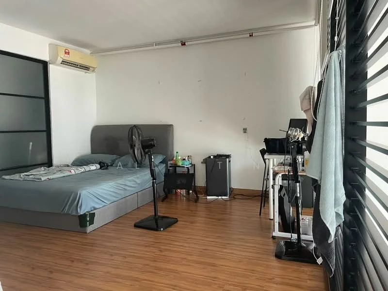 Bedroom features: queen-size bed with grey upholstered headboard, wooden flooring, 1 wall-mounted split AC, black standing fan, desk with chair, black cabinet, window with horizontal slats, decorative items on desk, bedside table, bedding with patterned duvet; style: modern.
