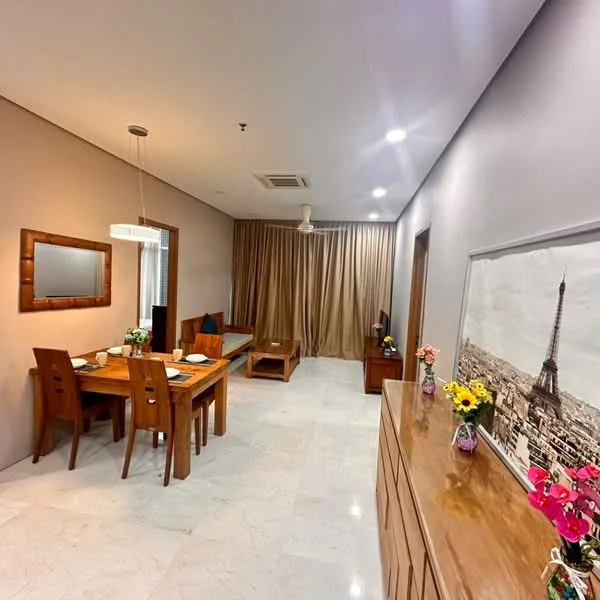 Living features: marble tile flooring, white painted walls, recessed downlights, 5-blade ceiling fan, wooden dining table with 4 chairs, wooden sideboard, sofa in brown fabric, framed artwork of Eiffel Tower, curtains in beige, TV console, decorative flowers in vases; style: modern.