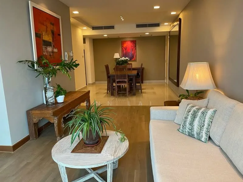 Living features: light grey painted walls, wooden flooring, 3-seater fabric sofa in light beige, decorative throw pillows, round coffee table with whitewashed finish, indoor plants in ceramic pots, floor lamp with fabric shade, wall-mounted artwork with abstract design, recessed downlights, open layout to dining area; style: modern. Dining features: wooden dining table for six, upholstered dining chairs, decorative centerpiece on table, wall-mounted artwork with floral design, recessed downlights, open layout to living area; style: modern.