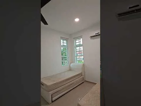 Bedroom features: two single beds, white painted walls, light grey flooring, ceiling fan, two windows with grilles, air conditioning unit, built-in wardrobe, natural light from windows; style: modern; view: garden.