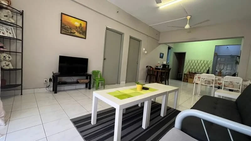 Living features: white painted walls, ceramic tile flooring, 5-blade ceiling fan, sofa in black, coffee table with white surface, area rug with striped pattern, TV console, wall-mounted TV, decorative wall art, green plastic chair, open shelving unit with stuffed animals; style: modern. Dining features: dining table with wooden surface, 4 wooden dining chairs, wall-mounted mirror, light green wall, doorway leading to other rooms; style: modern.