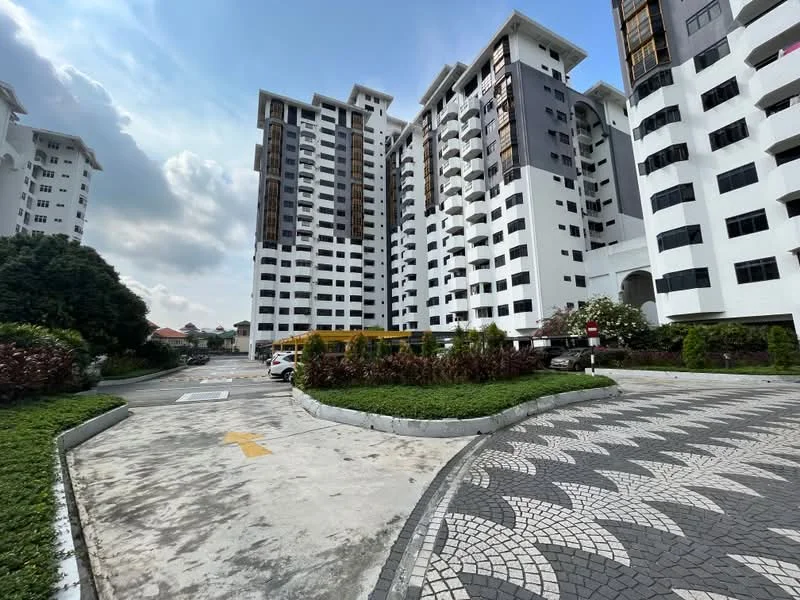 Exterior type: mid-rise condominium; features: white painted facade, grey accent panels, balconies with glass railings, landscaped garden with shrubs, paved driveway, parking spaces visible, surrounded by greenery, multiple storeys, modern architectural design; style: modern.