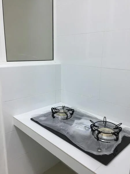Kitchen features: white tiled walls, white countertop, 2-burner gas hob, stainless-steel burners, black stove mat, window, neutral flooring; style: modern.