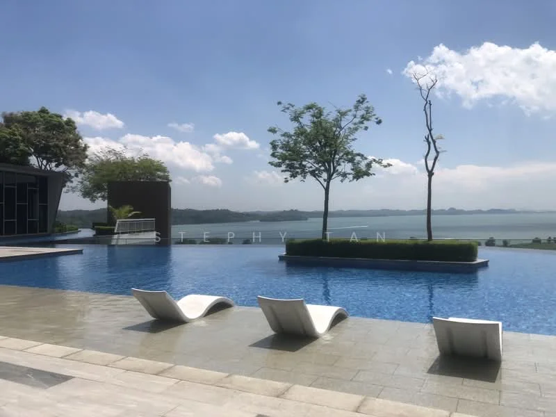 Exterior type: swimming pool deck; features: infinity pool, pool deck with loungers, landscaped garden with trees, waterfront view, stone-paved walkway, surrounded by greenery; style: modern.