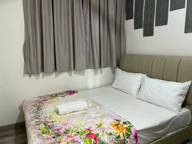 Bedroom features: queen-size bed, upholstered headboard, white bedding, floral patterned blanket, two white pillows, grey curtains, wooden flooring, decorative wall with grey accents; style: modern.