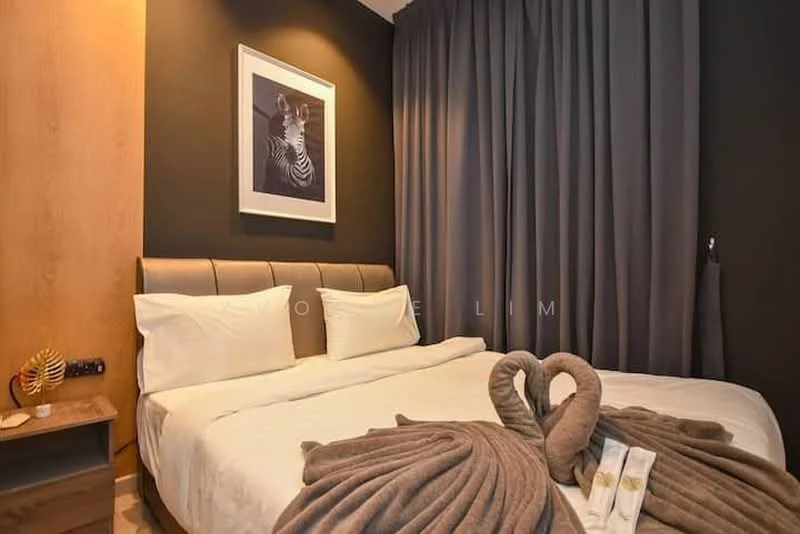 Bedroom features: king-size bed, upholstered headboard, white bedding, grey throw blanket, decorative towel swans, nightstand with drawer, framed artwork on wall, dark grey curtains, wood panel accent wall, soft lighting; style: modern.