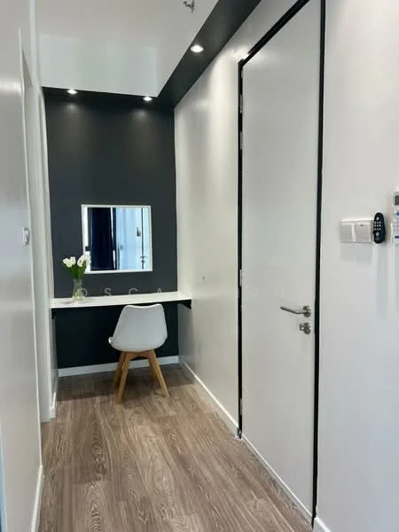 Room features: white painted walls, dark accent wall, wooden flooring, vanity table with mirror, single white chair, recessed downlights, door with modern handle, intercom panel, wall-mounted keyless entry pad; style: modern.