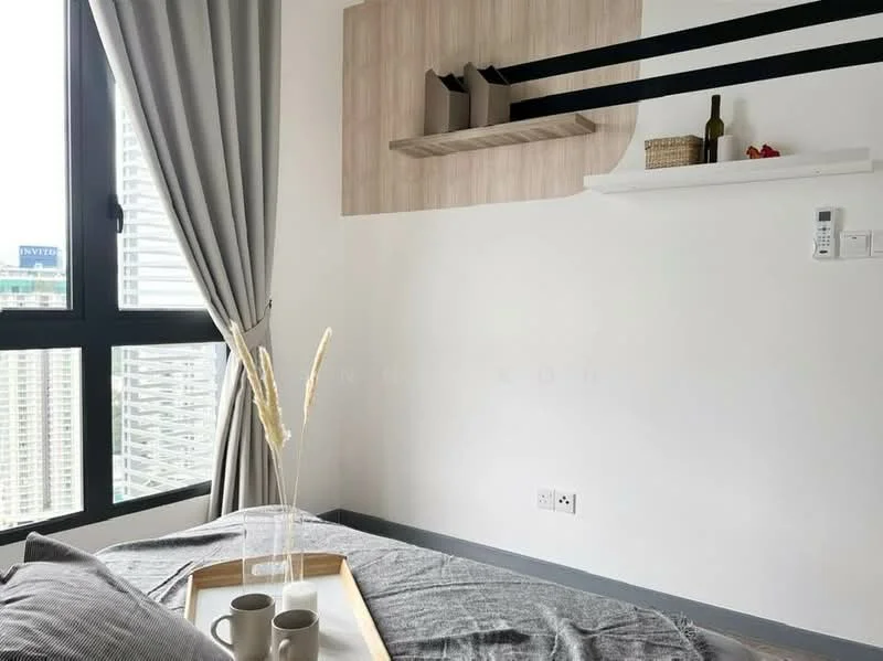 Bedroom features: grey bedding, wooden wall shelf, decorative vase with dried flowers, two cups on a tray, floor-to-ceiling window, curtains in light grey, white painted walls, grey carpet flooring; style: modern; view: city.