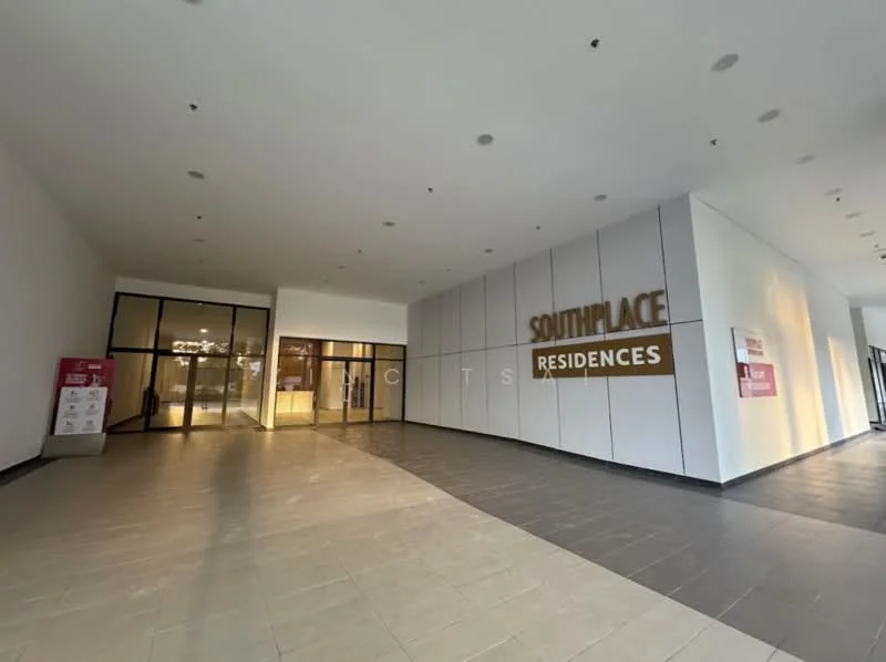 Exterior type: high-rise condominium; features: glass entrance doors, white painted facade, recessed lighting, tile flooring, feature wall with lettering, open lobby area, signage for Southplace Residences, modern architectural design; style: modern.