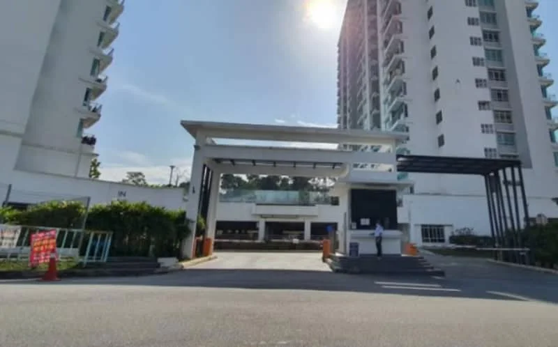 Exterior type: high-rise condominium; features: modern entrance gate, covered drop-off area, security guard station, landscaped greenery, driveway with interlocking pavers, multi-storey building, glass facade, parking area visible; style: modern.