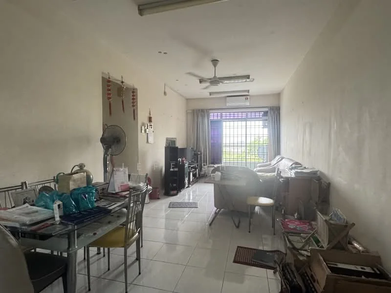 Living features: white painted walls, glossy white tile flooring, 5-blade ceiling fan, large window with view, curtains, sofa, dining table with chairs, TV console, air conditioning unit, decorative items on shelves, boxes and clutter; view: garden.