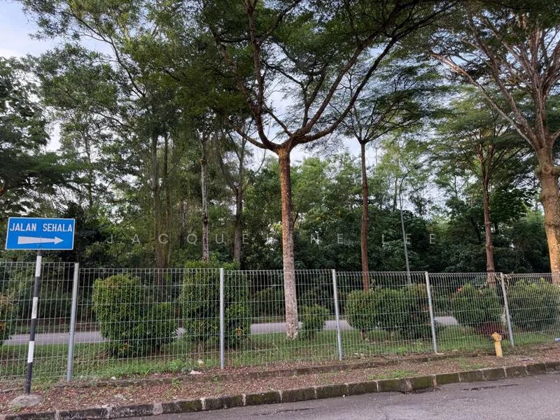 Exterior features: fenced area, road sign indicating Jalan Sehala, mature trees, landscaped bushes, paved road, greenery surrounding the area.