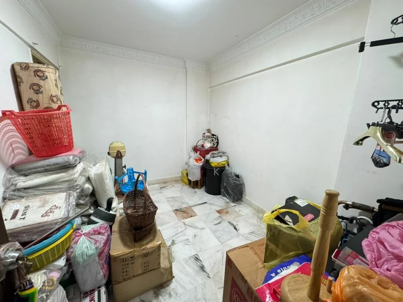 Room features: white painted walls, marble flooring, plastic storage bins, cardboard boxes, waste bins, baskets, various bags, cluttered storage items.