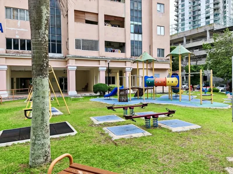 Exterior type: clubhouse; features: playground equipment, swings, slide, climbing structure, manicured lawn, paved pathways, outdoor seating area, surrounding greenery, multi-storey car park in background; style: modern.