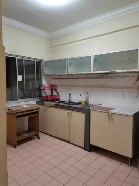 Kitchen features: white painted walls, tile backsplash, grey countertop, single-bowl stainless-steel sink, chrome pull-down faucet, upper cabinets with glass fronts, lower cabinets in cream color, wooden cart on wheels, window with metal frame, tile flooring in light beige.