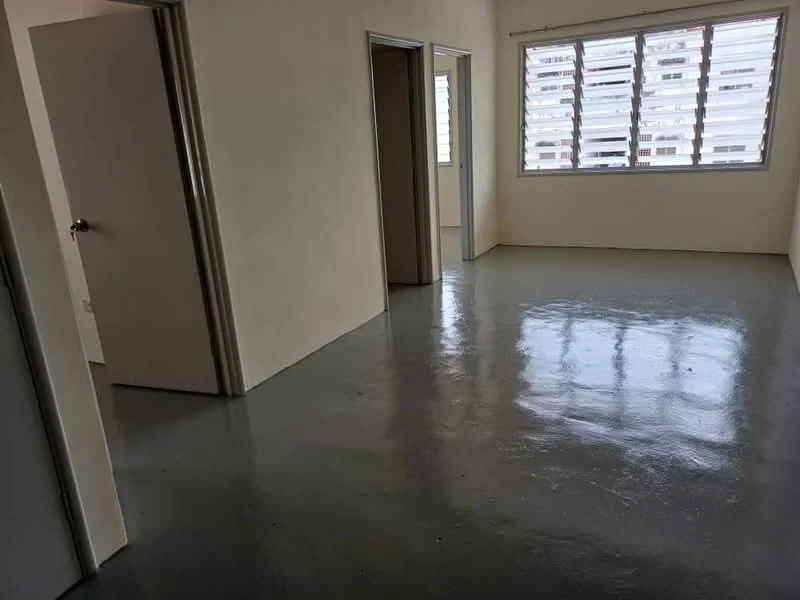 Room features: white painted walls, grey polished concrete flooring, floor-to-ceiling windows, sliding door, two doors leading to other rooms, natural light from windows.