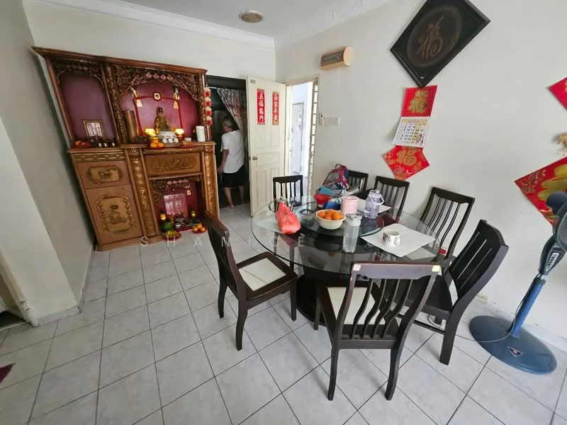 Dining features: round glass dining table, 6 wooden dining chairs, ceramic floor tiles, wooden display cabinet with carvings, decorative wall hangings, red and gold decorations, fruit bowl with oranges, plastic containers on the table; style: traditional.