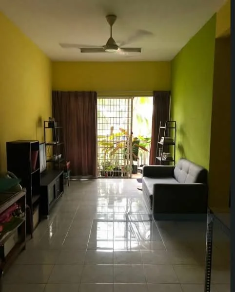 Living features: yellow painted walls, green accent wall, white tiled flooring, 5-blade ceiling fan, sofa in grey, bookshelves, curtains in brown, sliding glass door, balcony view with plants; style: modern; view: garden.