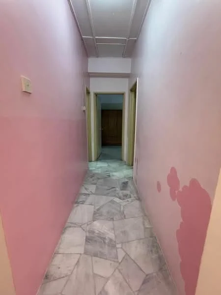 Hallway features: pink painted walls, marble flooring, two doorways leading to other rooms, ceiling with exposed beams, light fixture on ceiling.