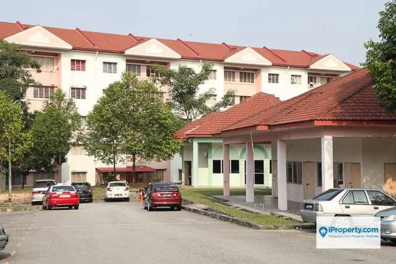 Exterior type: low-rise apartment block; features: red pitched tile roof, cream painted facade, green accent walls, landscaped garden with trees, open-air parking lot, multiple car porches, surrounded by mature greenery; style: modern.