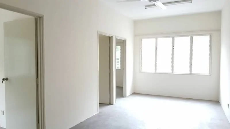 Room features: white painted walls, grey concrete flooring, 5-blade ceiling fan, large windows with multiple panes, doorway leading to another room, doorway leading to bathroom, natural light from windows; style: minimalist.