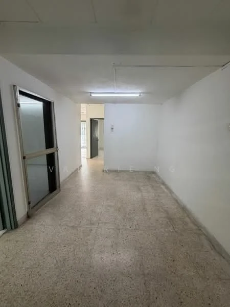 Room features: white painted walls, exposed ceiling, fluorescent lighting, terrazzo flooring, sliding glass door, doorway leading to another room.