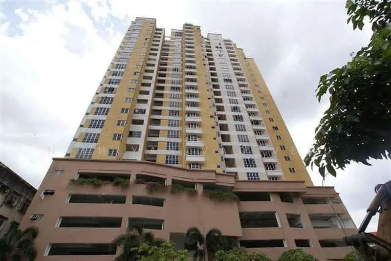 Exterior type: high-rise condominium; features: yellow and white painted facade, glass windows, multiple balconies, parking deck visible at the base, landscaped areas at the base, approximately 20-storey high-rise; style: modern.