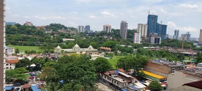 Exterior type: high-rise condominium; features: city skyline view, surrounded by greenery, visible construction site, urban landscape, park area, multi-storey buildings, residential area, road with parked cars; style: modern.