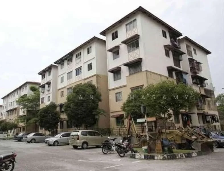 Exterior type: low-rise apartment block; features: white painted facade, cream painted facade, balconies with railings, multiple storeys, parking area, landscaped greenery, trees surrounding the building, visible vehicles in parking area; style: modern.