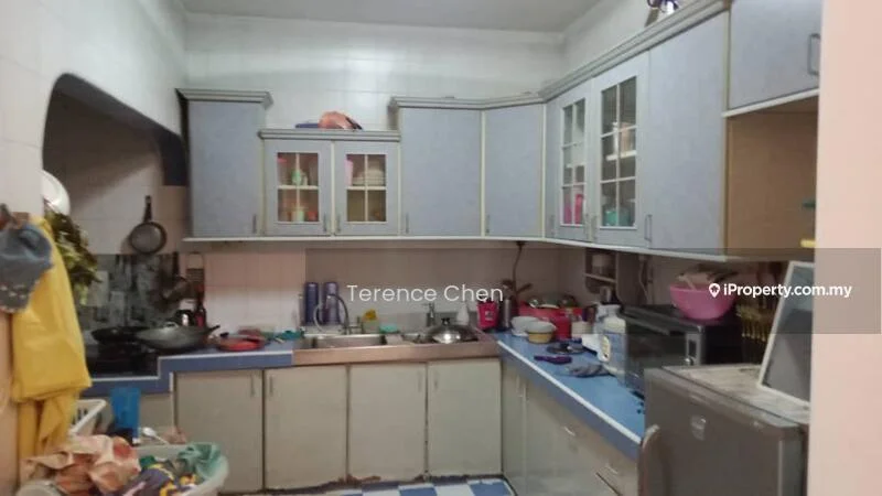 Kitchen features: blue laminate countertops, light grey cabinetry with glass-front upper cabinets, stainless-steel sink, chrome faucet, built-in microwave, freestanding range oven, refrigerator, tile flooring, wall-mounted shelves, kitchen utensils and appliances visible, cluttered countertop, white tiled walls.