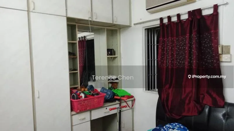 Room features: built-in wardrobe with sliding doors, mirror on wardrobe, red curtains, window with security bars, air conditioning unit, black leather sofa, basket with assorted items, various personal items on the floor.