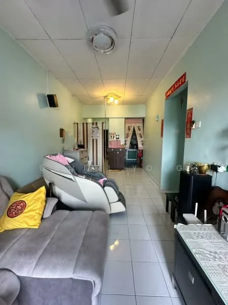 Living features: grey fabric sofa, yellow decorative pillow, white tiled flooring, light green painted walls, ceiling fan, recessed ceiling lights, wall-mounted TV, wooden cabinet, decorative items on side table, doorway leading to kitchen, curtains on windows; style: modern.